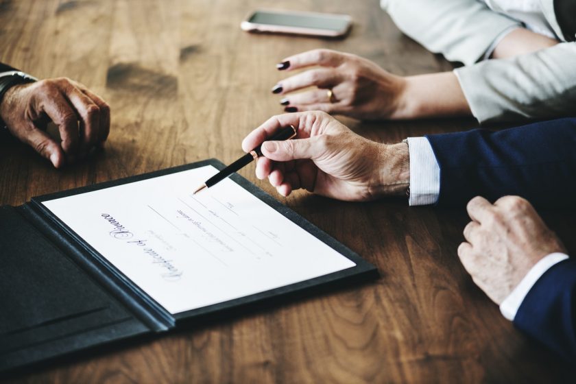 A man points a pen at a 'Certificate of Divorce'.